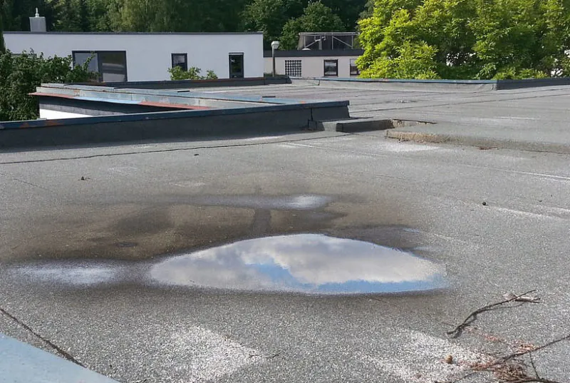 Water pooling on a flat roof membrane
