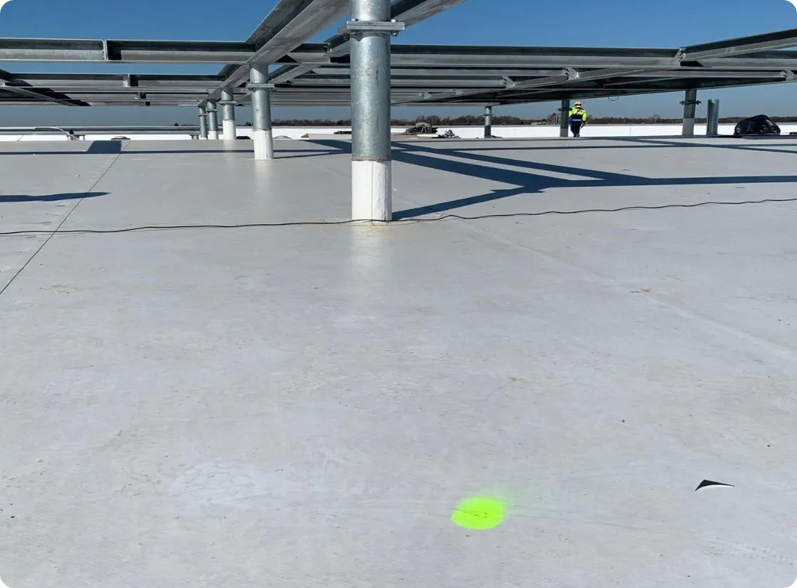 ELD inspector marking a membrane breach on PVC rooftop